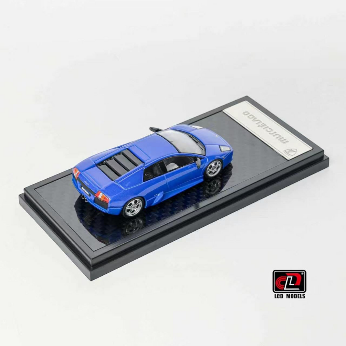 Lot57Supplies Diecast Shop blue LCD Lamborghini Murciélago 1:64 scale diecast model car on a display base