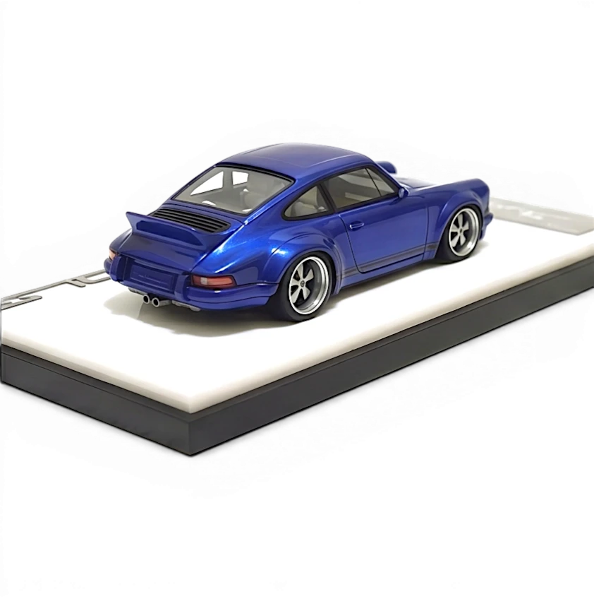 Lot57Supplies Diecast Shop blue metallic resin Singer DLS 1:64 scale model car with spoiler and display base.