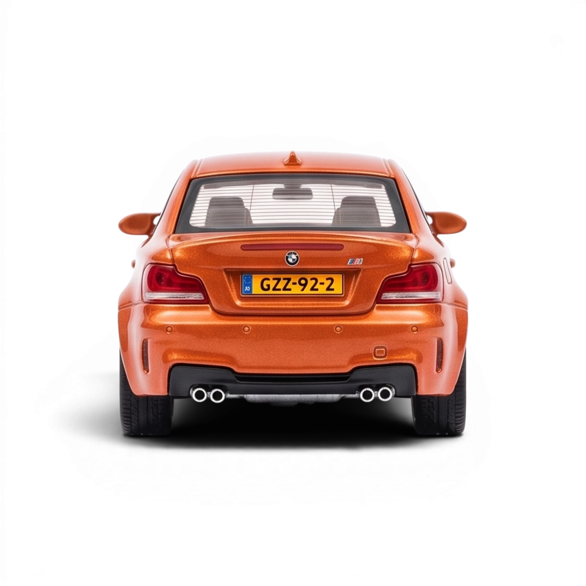 Lot57Supplies Diecast Shop MORTAL BMW 1M Coupe diecast model in Valencia Orange, rear view showing dual exhaust pipes.