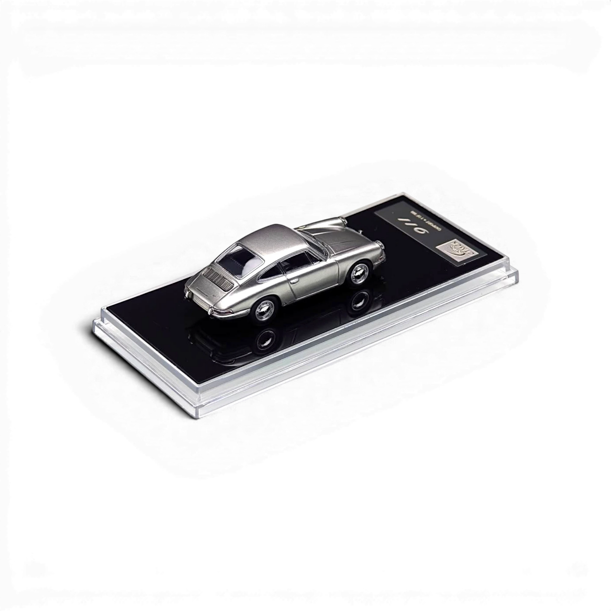 Lot57Supplies Diecast Shop Carport Model 911 diecast car in GT Silver, 1:64 scale on a black display base.