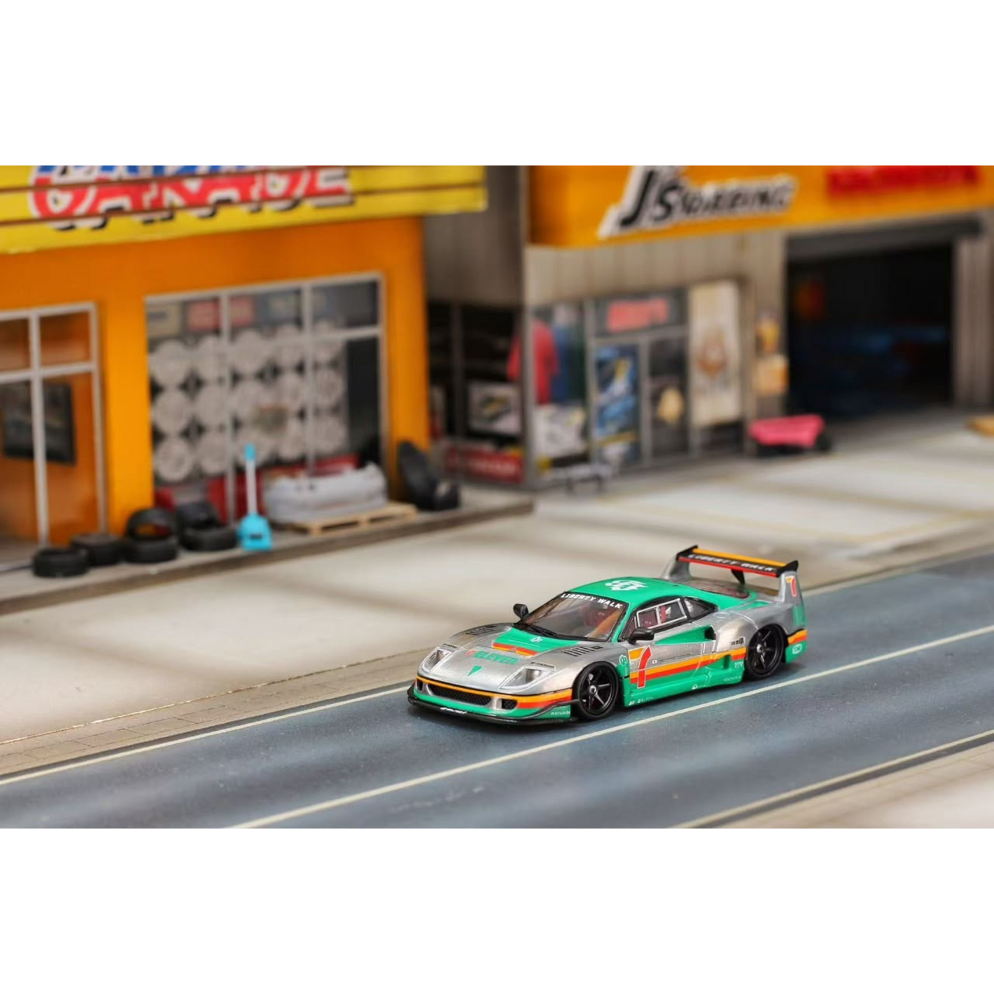 Lot57Supplies Diecast Shop 1:64 scale GHOST PLAYER Ferrari F40 diecast model car with 7-Eleven livery on a diorama road