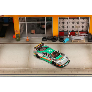 Lot57Supplies Diecast Shop GHOST PLAYER Ferrari F40 1:64 scale diecast model with 7-Eleven livery in a garage diorama