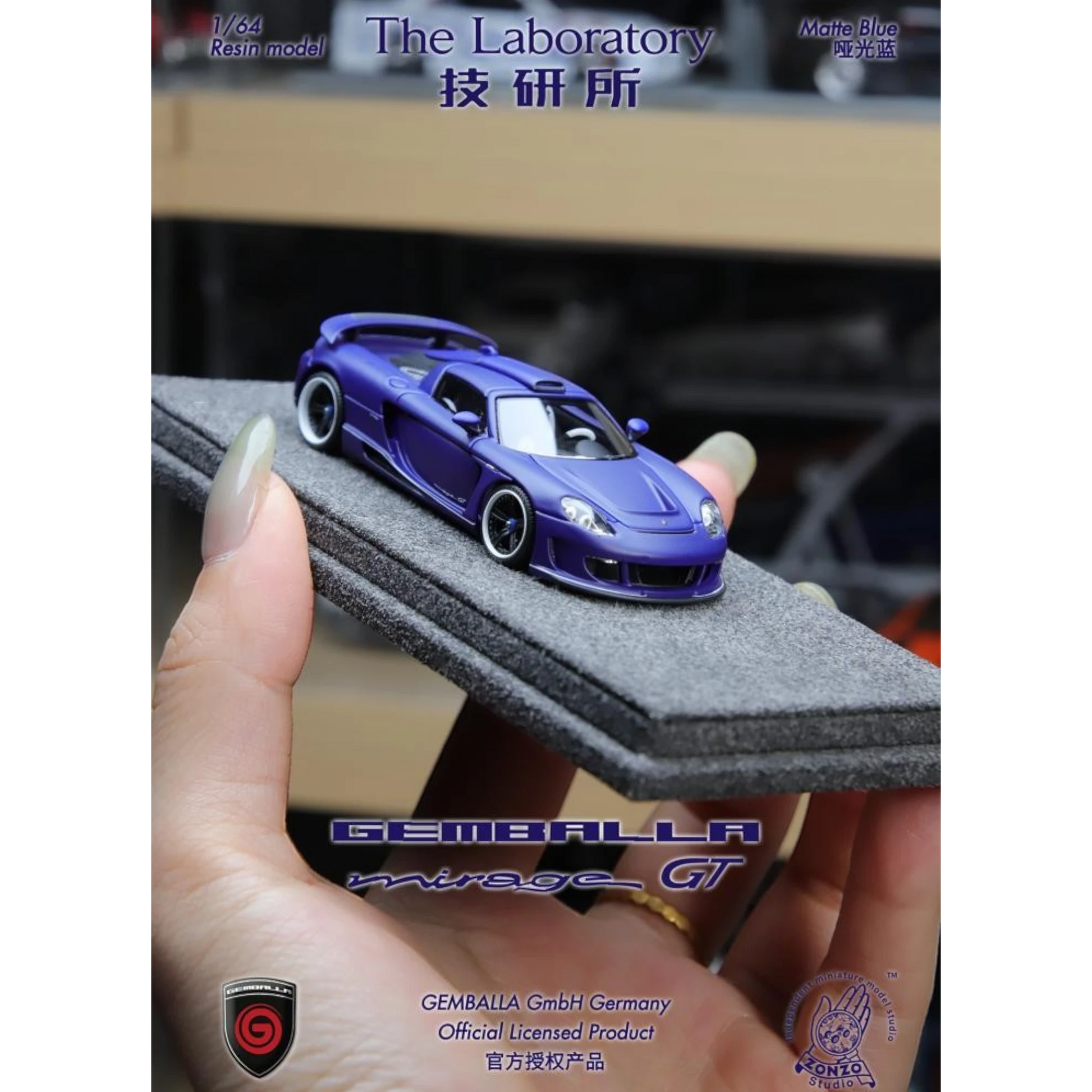 Lot57Supplies Diecast Shop 1:64 scale matte blue resin Gemballa Mirage GT model car on a grey foam display base.