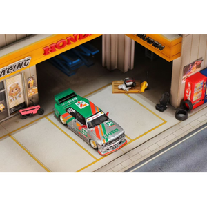 Lot57Supplies Diecast Shop GHOST PLAYER BMW E30 diecast model car in 7-Eleven livery parked in a miniature garage diorama