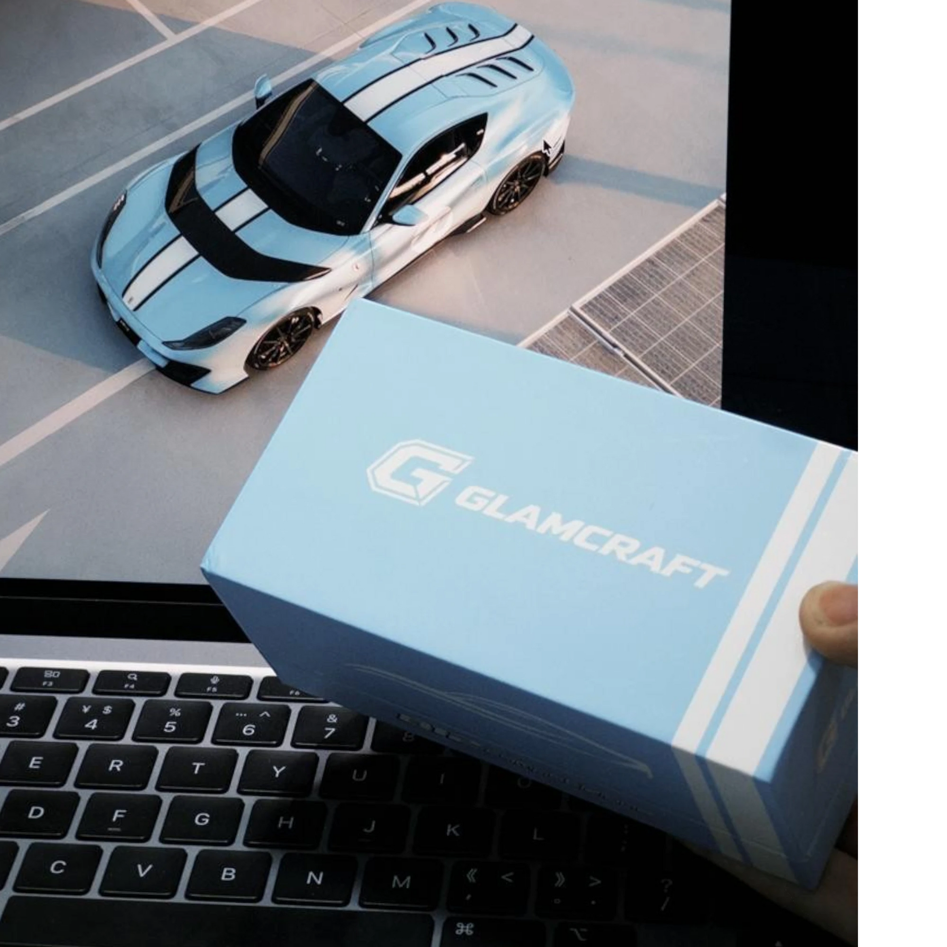 Lot57Supplies Diecast Shop GLAMCRAFT light blue Ferrari 812 Competizione diecast model box on a laptop