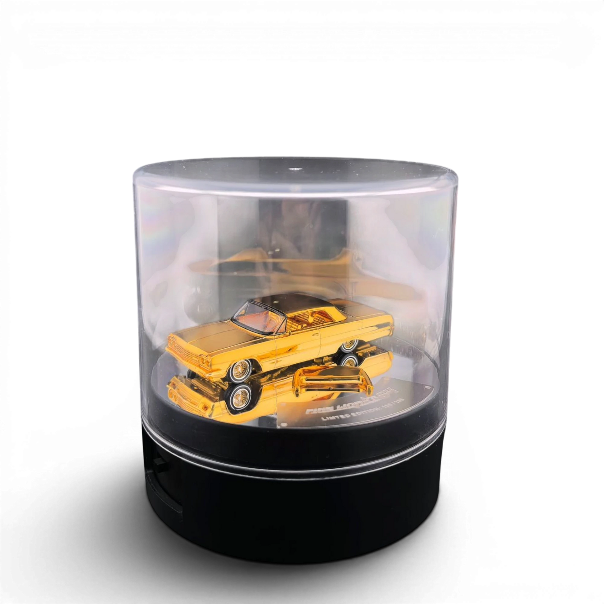 Lot57Supplies Diecast Shop 1:64 scale Fine Works 64 Chevrolet Impala lowrider in chrome gold on a display turntable