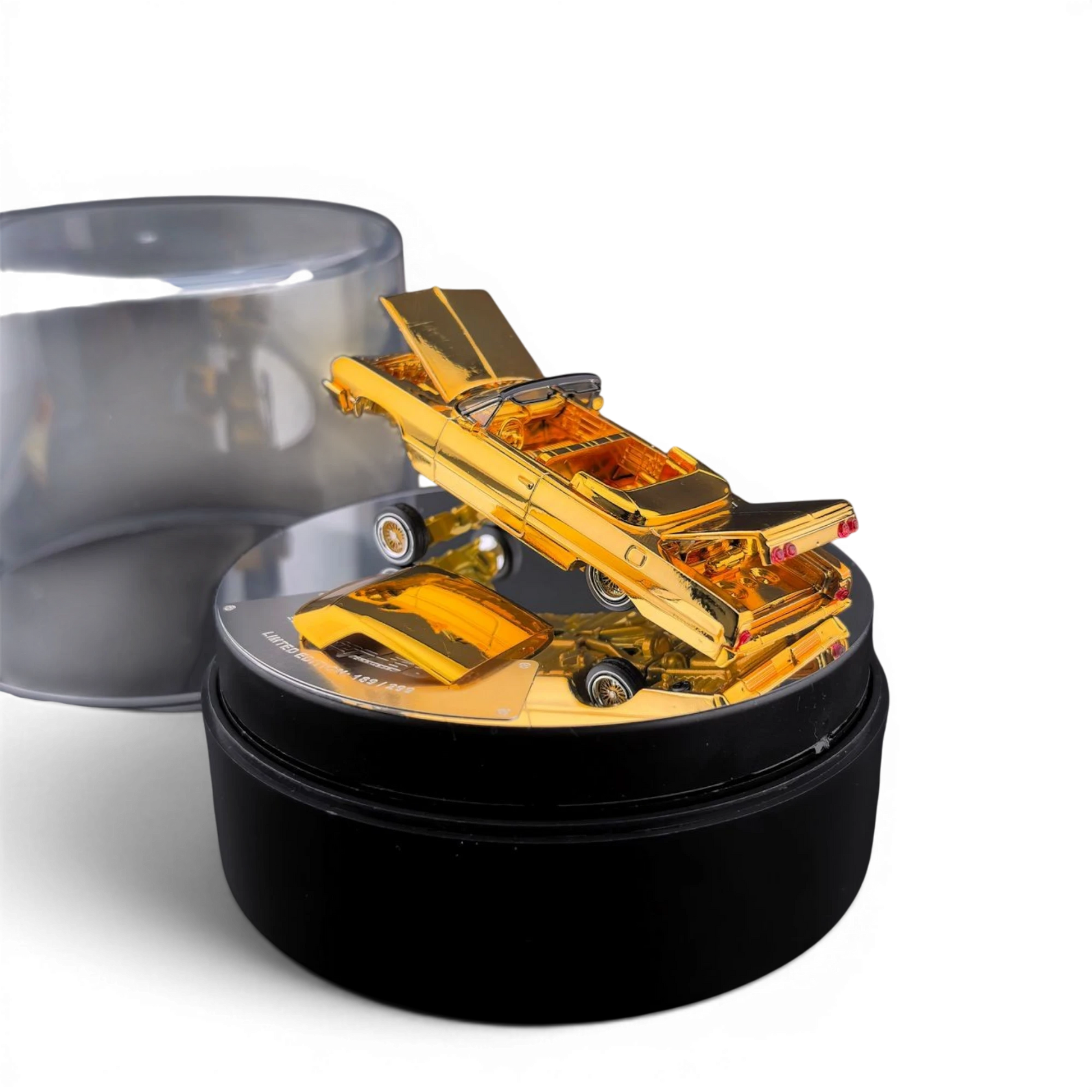 Lot57Supplies Diecast Shop 1:64 scale chrome gold Chevrolet Impala lowrider diecast car on an electric turntable.