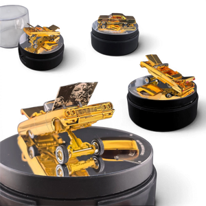 Lot57Supplies Diecast Shop 1:64 scale chrome gold Chevrolet Impala lowrider model with open hoods on a display stand.