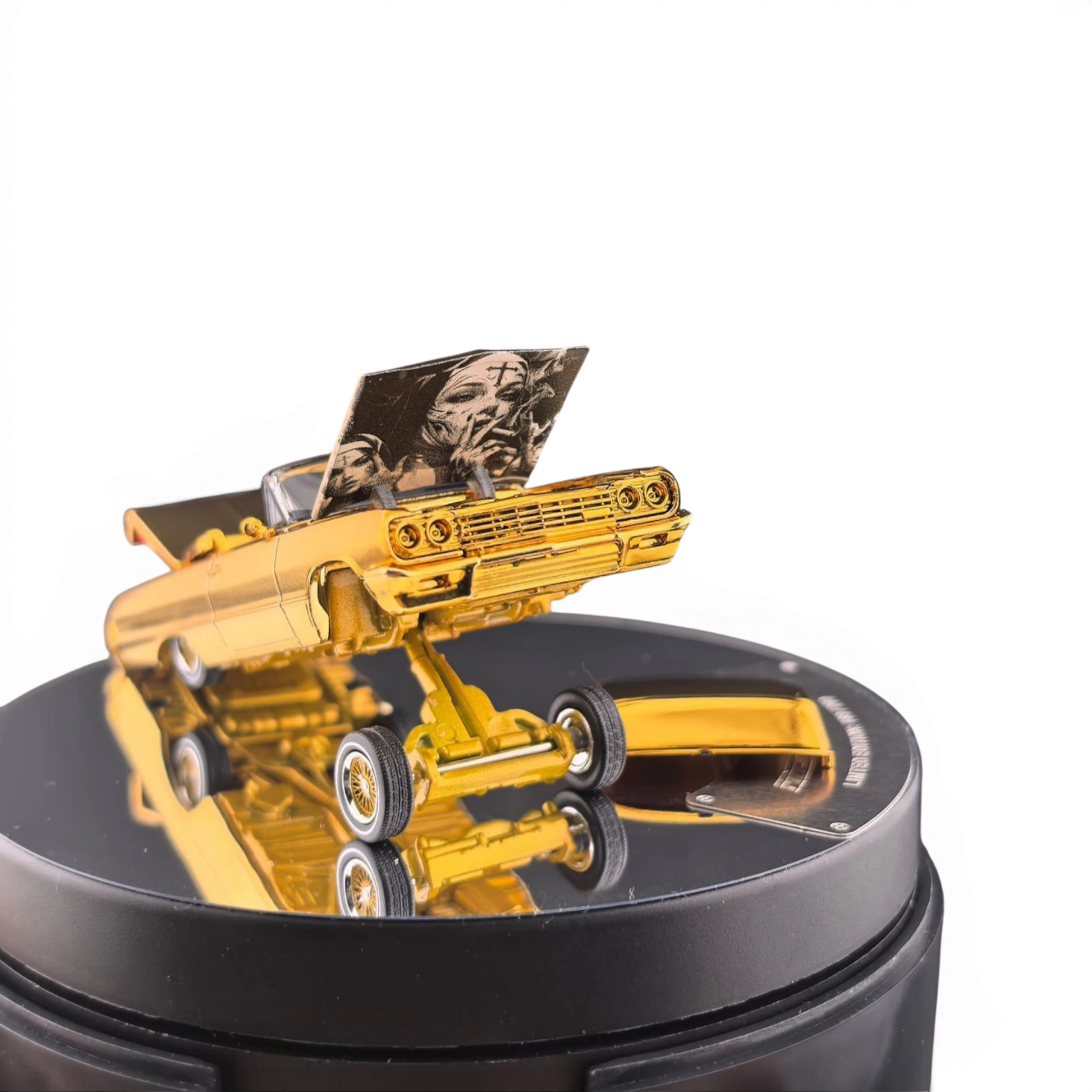 Lot57Supplies Diecast Shop 1:64 scale chrome gold Chevrolet Impala lowrider model with open hood on a display stand