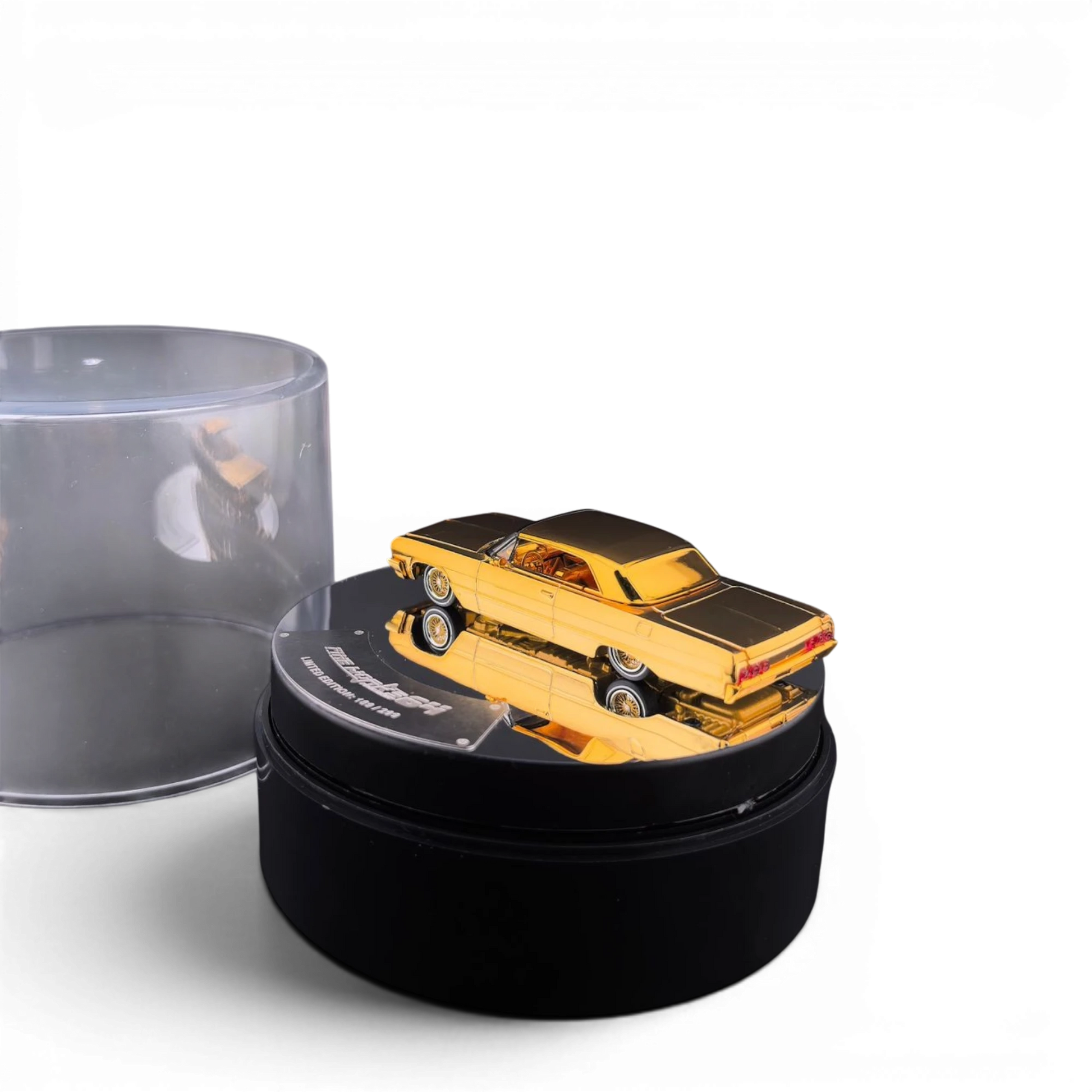 Lot57Supplies Diecast Shop 1:64 scale chrome gold Chevrolet Impala lowrider model on an electric display turntable