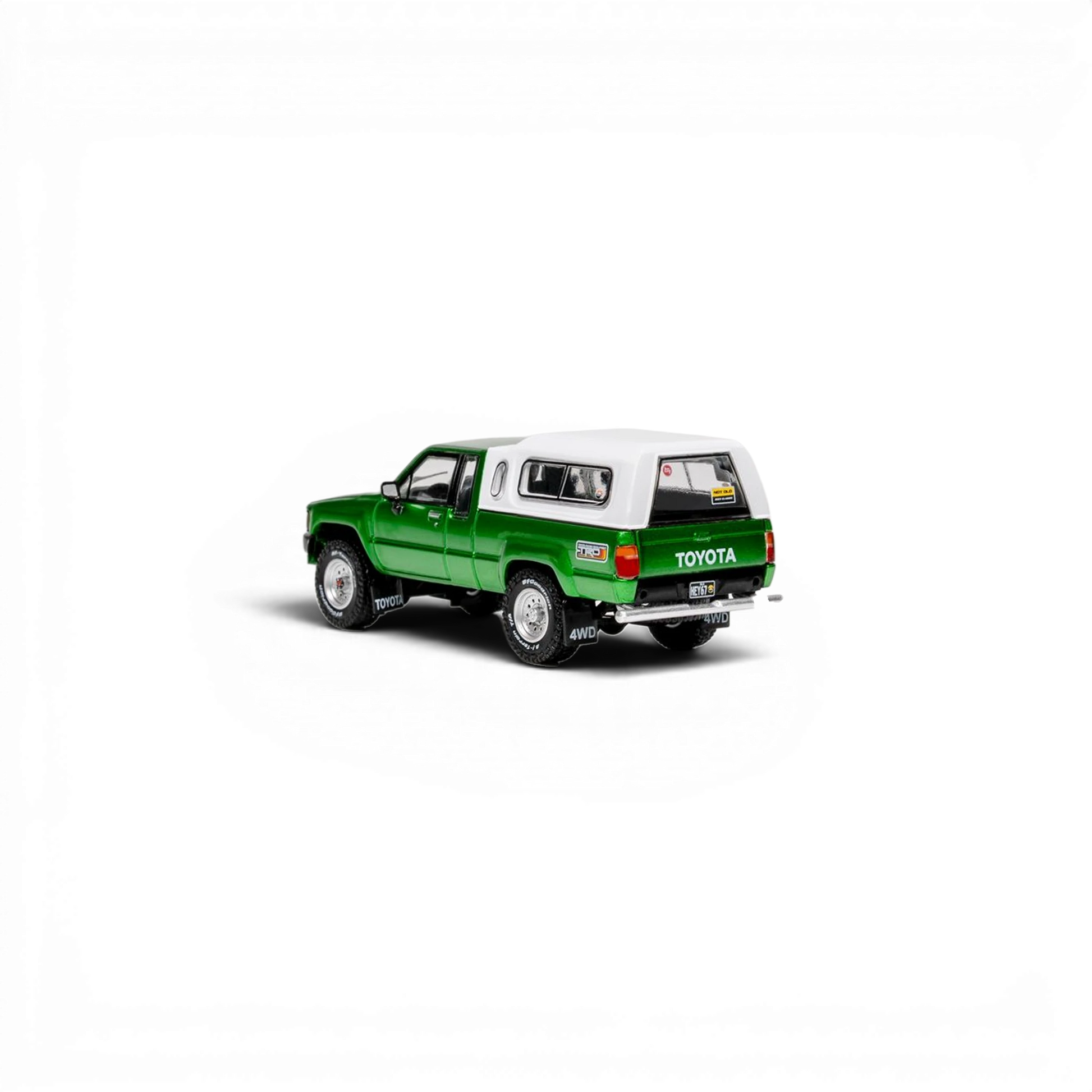 Lot57Supplies Diecast Shop GCD 1:64 scale green Toyota Hilux Xtra Cab diecast pickup truck with white camper shell