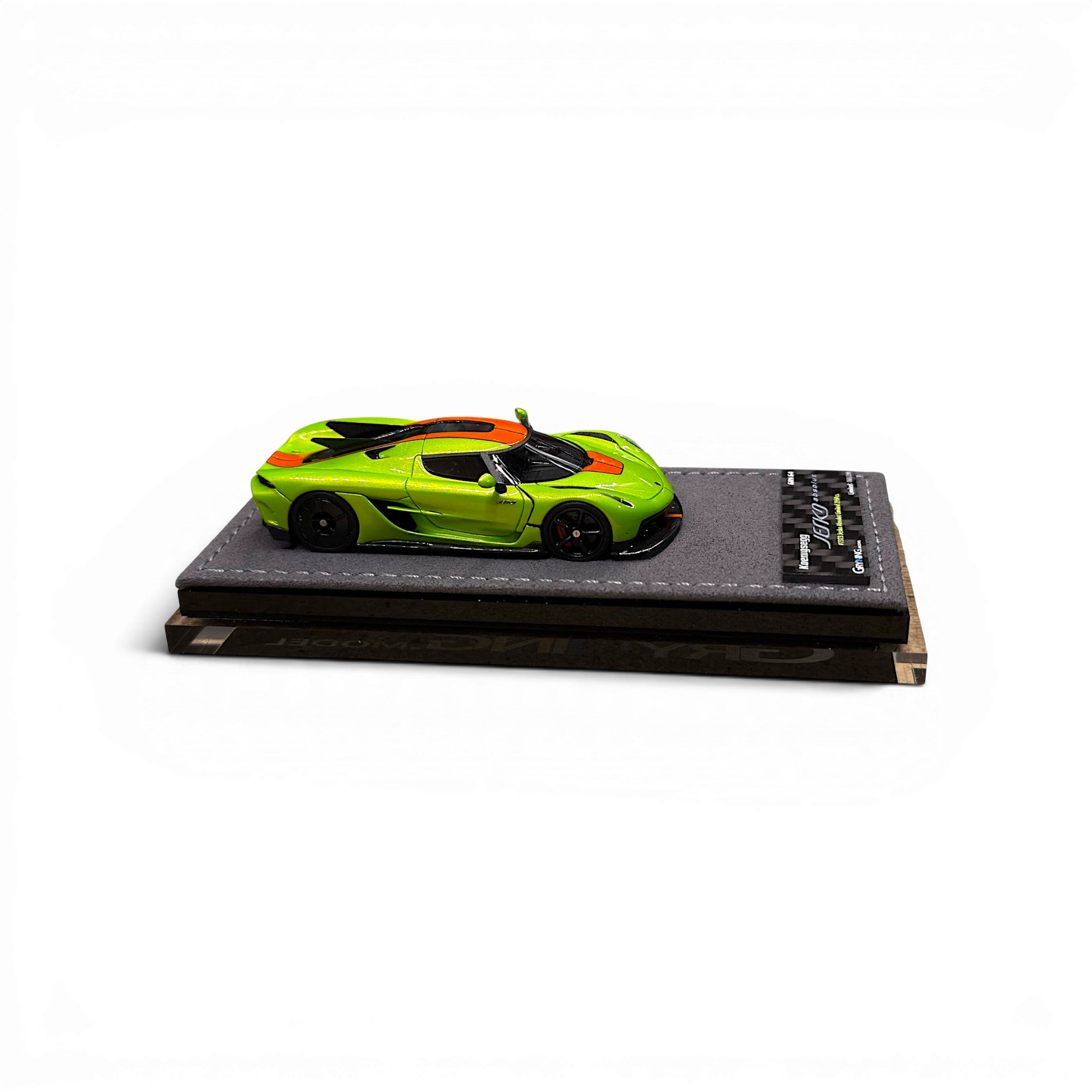 GRYNING Jesko Absolut 1:64 scale model in Jesko Green and Sweet Mandarin with carbon fiber details on a display base.
