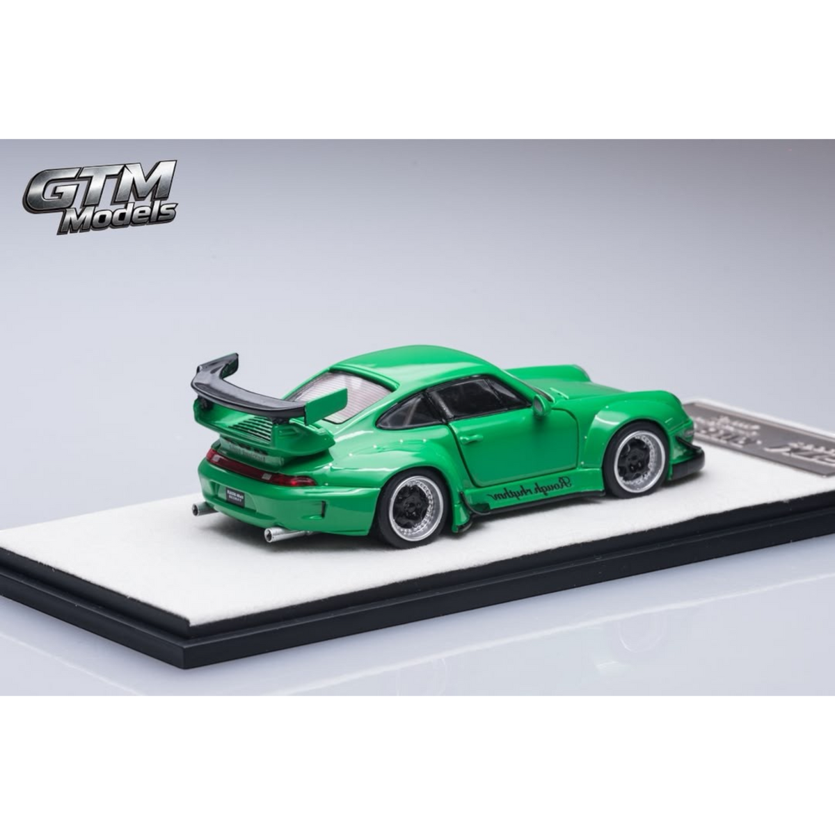 Lot57Supplies Diecast Shop GTM 1:64 scale RWB993 green diecast model car with rear wing on display base