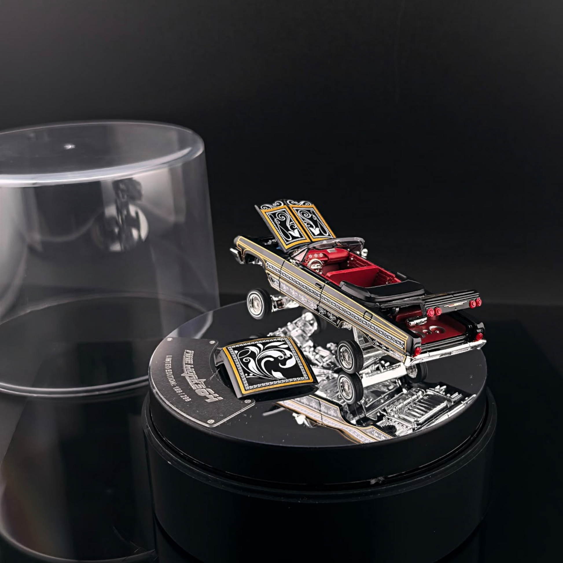 Lot57Supplies Diecast Shop 1:64 scale Fine Works64 Impala lowrider in black and gold with red interior on a turntable