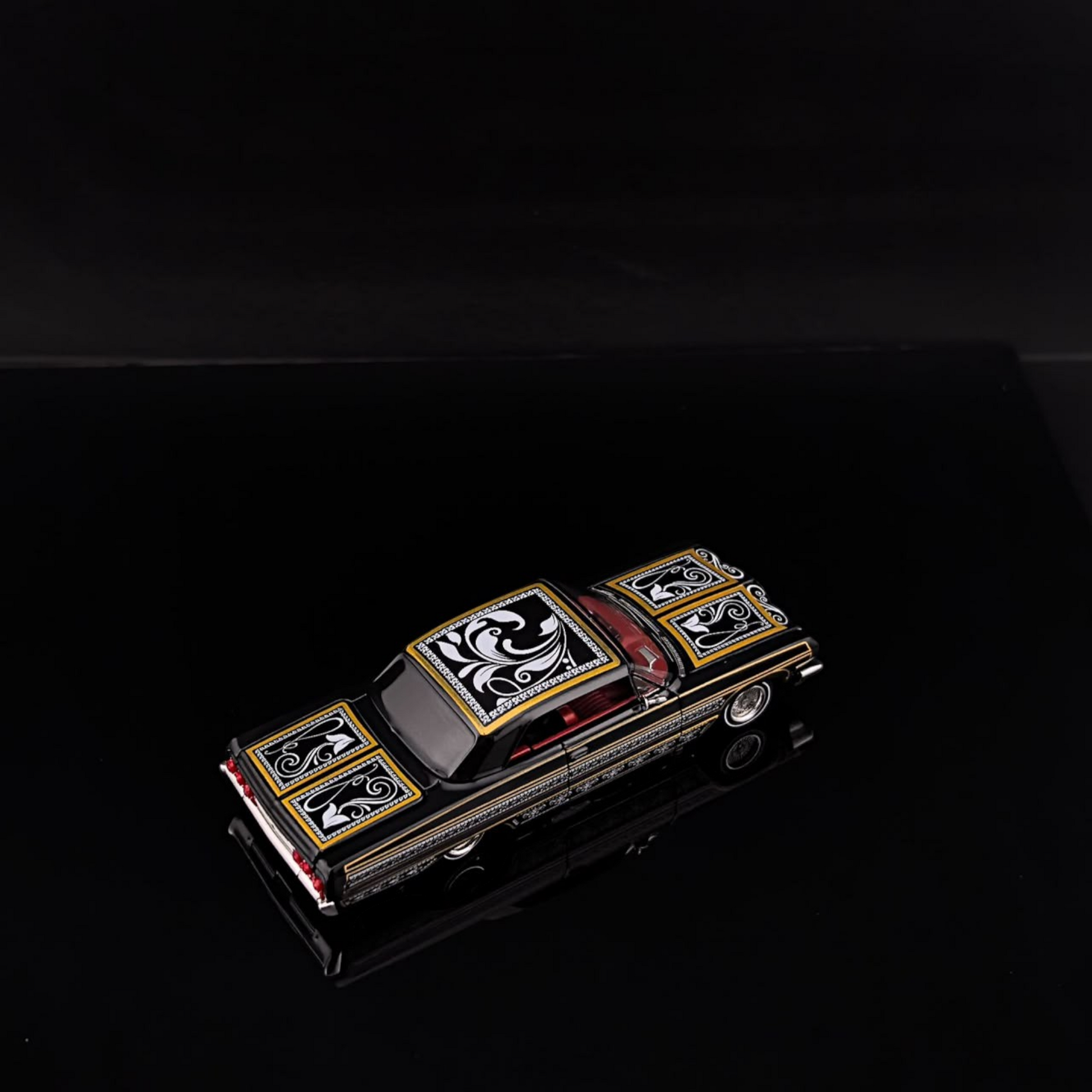Lot57Supplies Diecast Shop 1:64 scale Fine Works64 Impala lowrider diecast car in black and gold with intricate decals