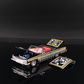 Lot57Supplies Diecast Shop 1:64 scale black and gold Impala lowrider diecast car with red interior and open hood