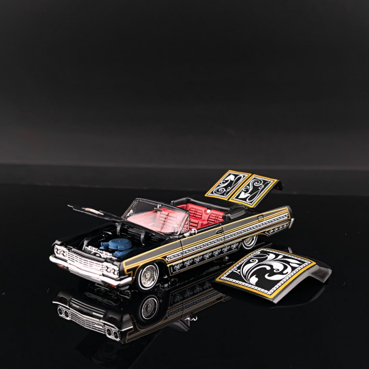 Lot57Supplies Diecast Shop 1:64 scale black and gold Impala lowrider diecast car with red interior and open hood