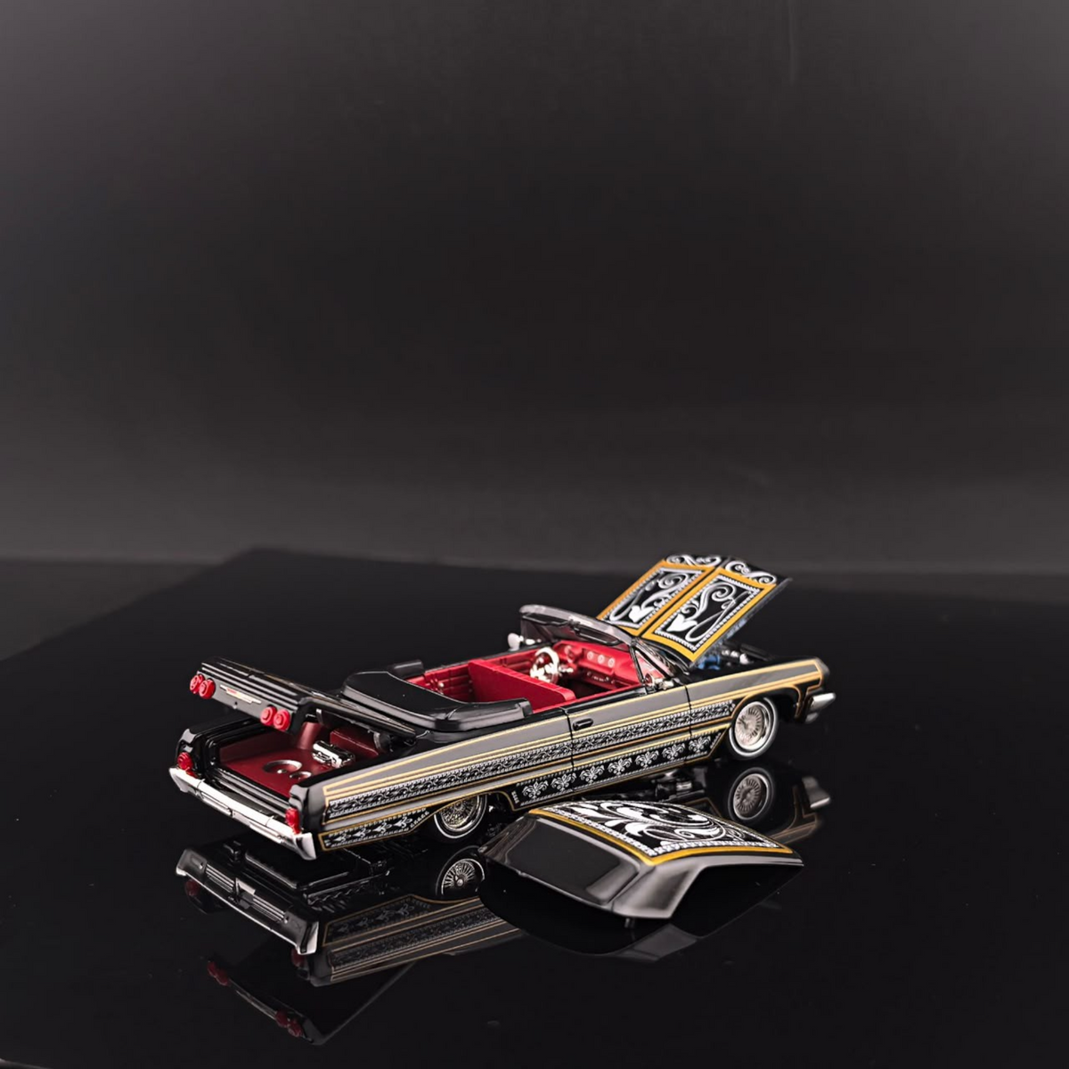 Lot57Supplies Diecast Shop Fine Works64 1:64 scale black and gold Impala lowrider diecast car with red interior