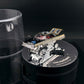 Lot57Supplies Diecast Shop Fine Works64 black and gold Impala lowrider diecast car on an electric display turntable