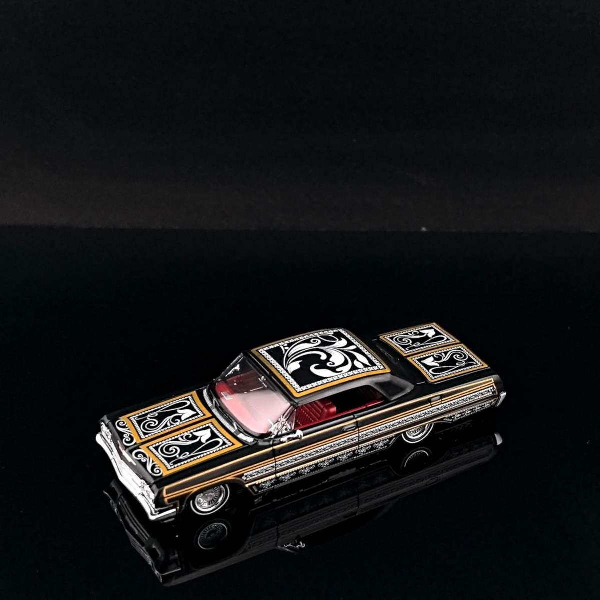 Lot57Supplies Diecast Shop 1:64 scale Fine Works64 Impala lowrider model car in black and gold with intricate detailing.