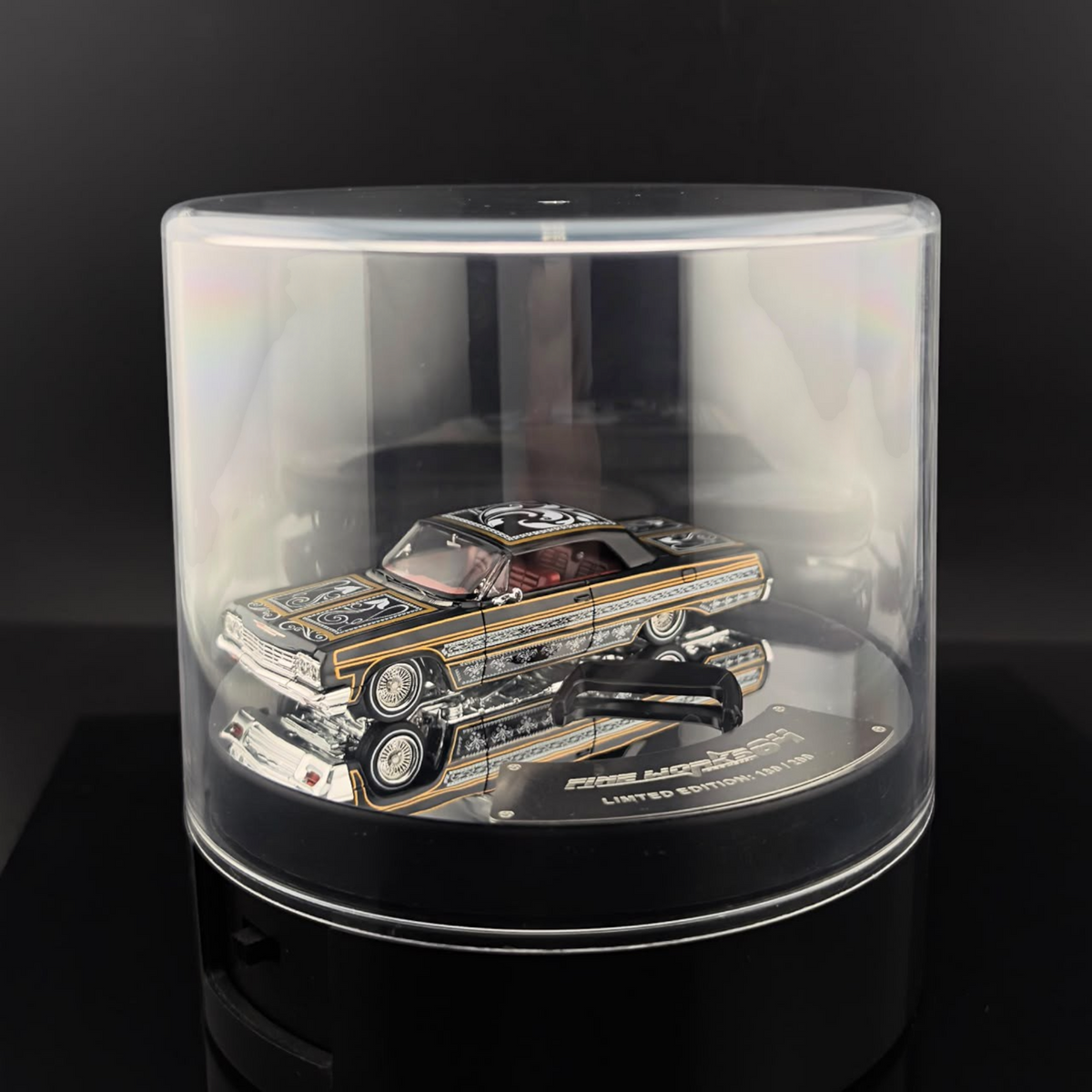 Lot57Supplies Diecast Shop Fine Works64 Impala lowrider diecast car in black and gold with electric display turntable
