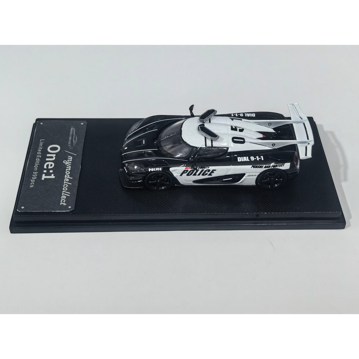 Lot57Supplies Diecast Shop 1:64 scale MC Koenigsegg One:1 diecast model car in black and white police livery.