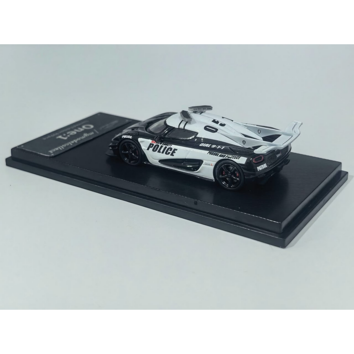 Lot57Supplies Diecast Shop 1:64 scale MC Koenigsegg One:1 diecast model car in black and white police livery