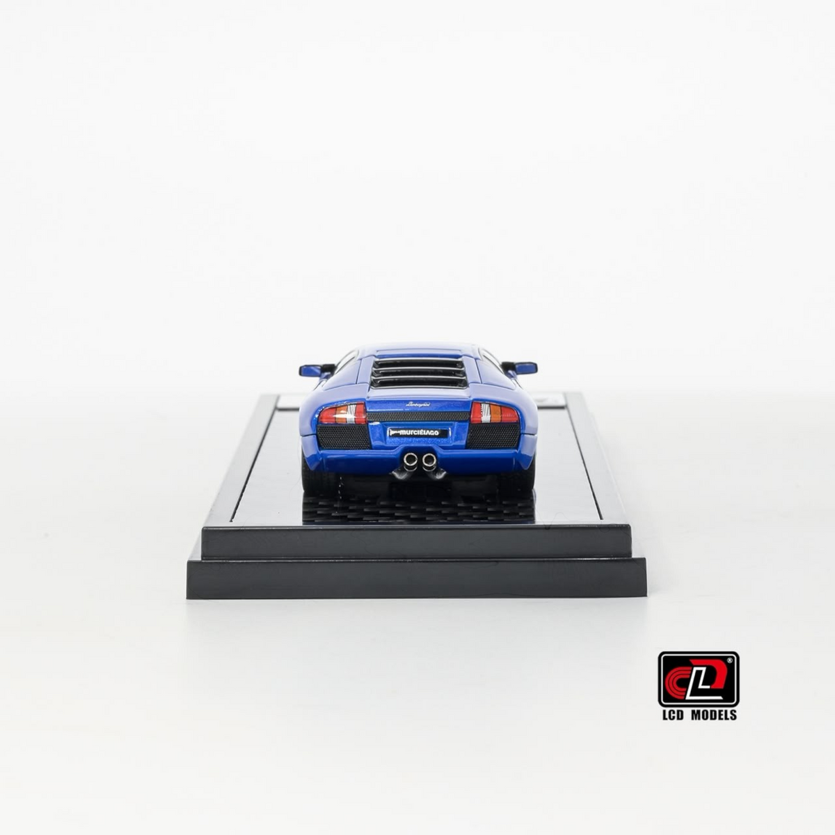 Lot57Supplies Diecast Shop LCD Lamborghini Murciélago 1:64 scale diecast model car in blue, rear view on display base.