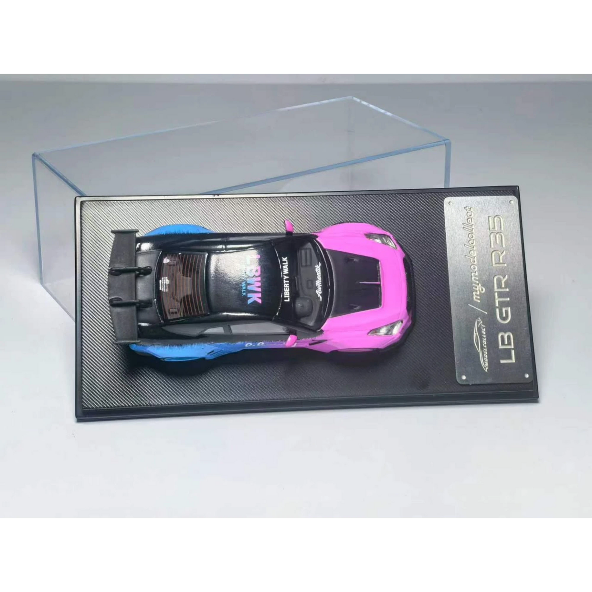 Lot57Supplies Diecast Shop 1:64 scale MC LB GTR 1.5 diecast model car in flash pink and blue livery on display base