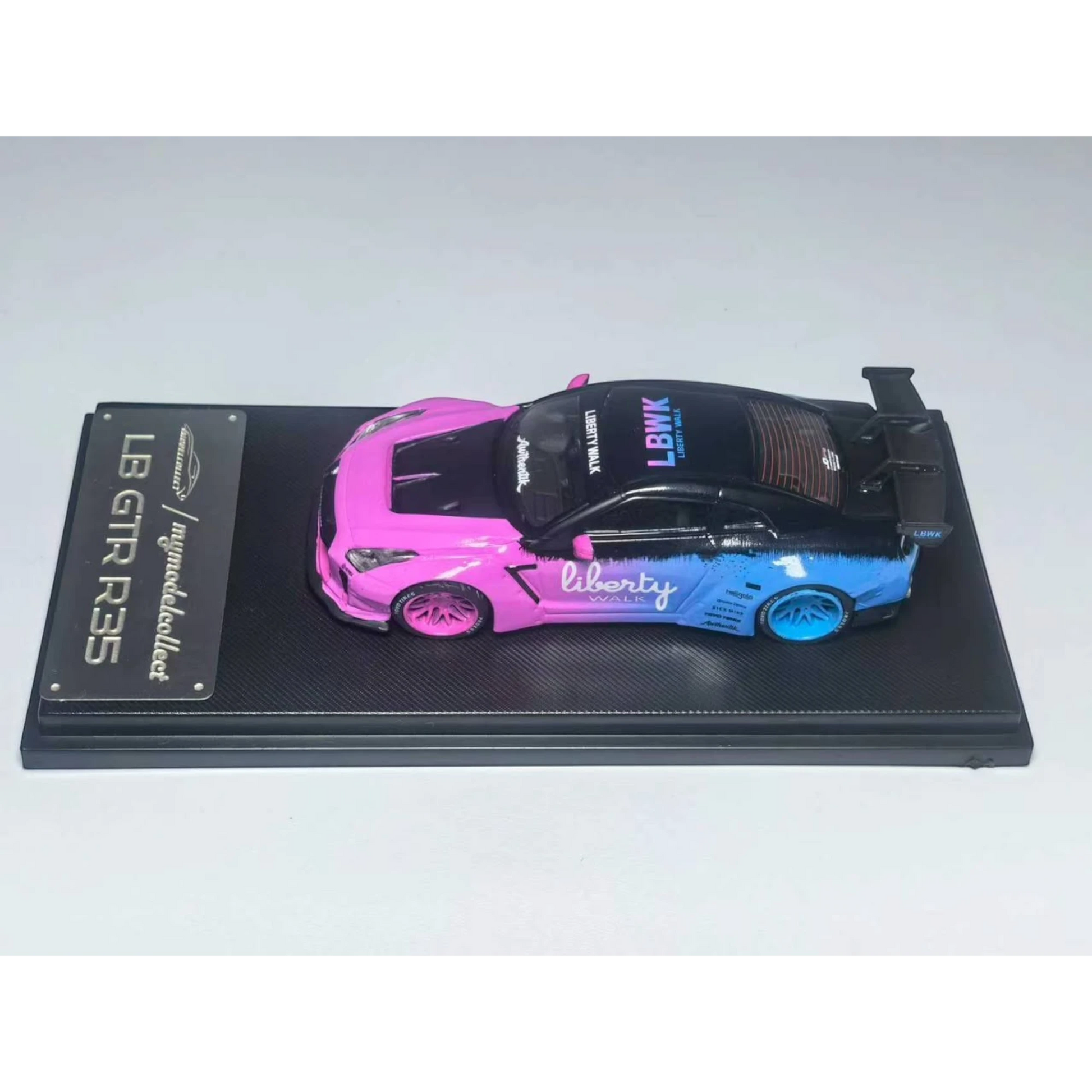 Lot57Supplies Diecast Shop 1:64 scale MC LB GTR 1.5 diecast model car in flash pink and blue livery on display base