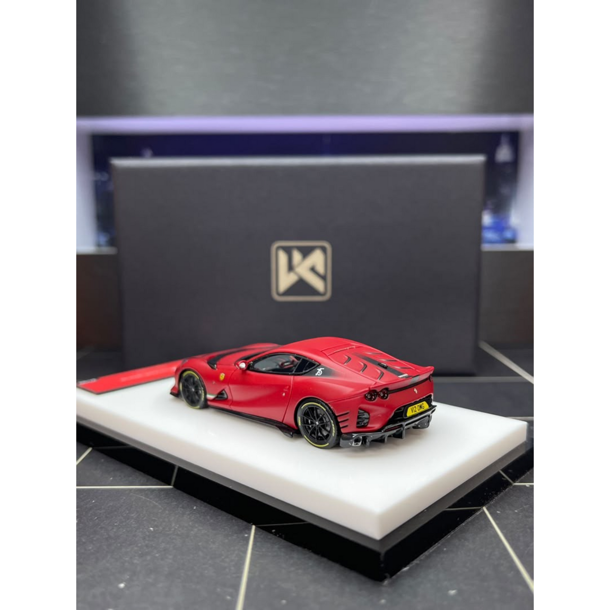 Lot57Supplies Diecast Shop matte red DMY Ferrari 812C 1:64 scale resin model car with black wheels on display base