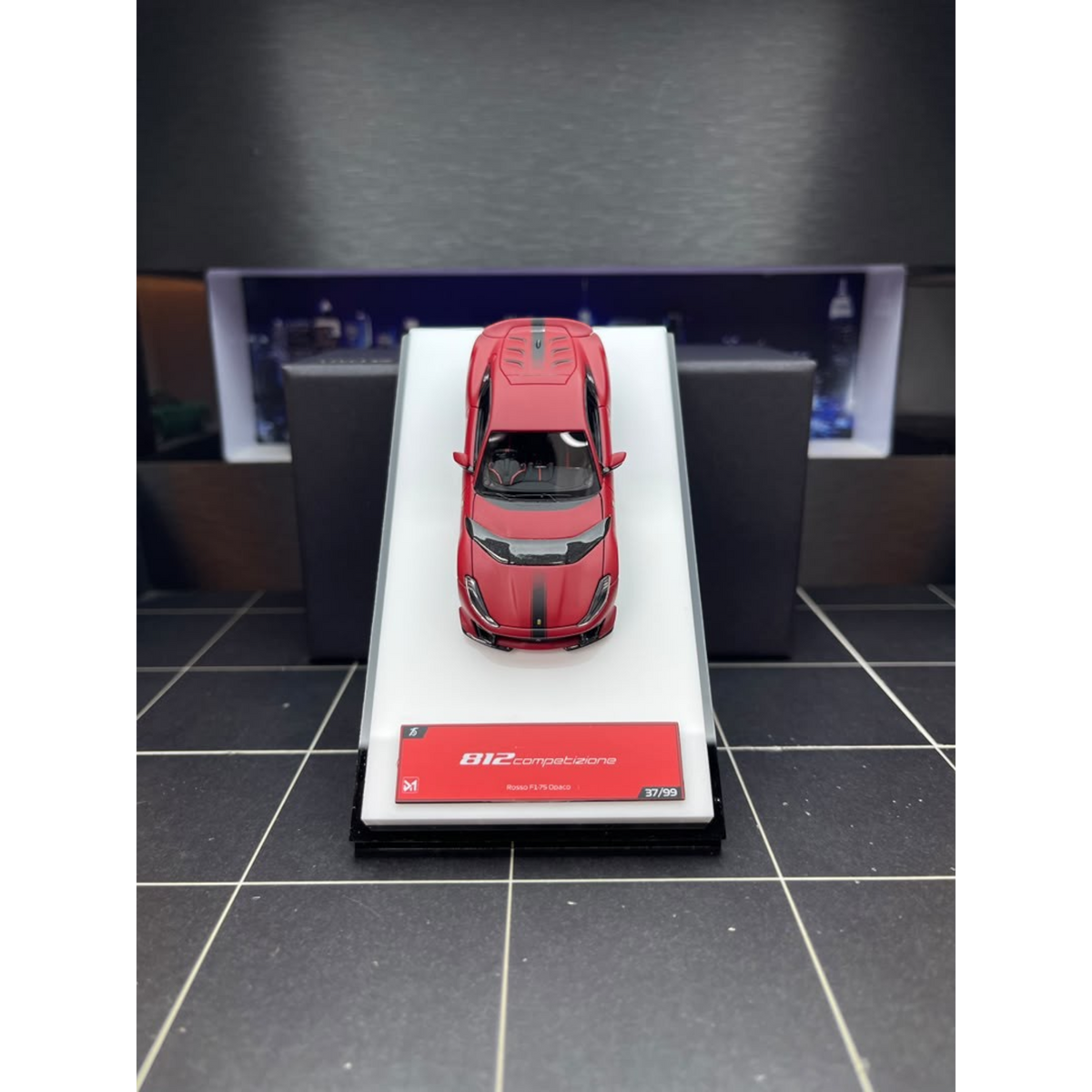 Lot57Supplies Diecast Shop DMY Ferrari 812C matte red model car in 1:64 scale with opening hood on display stand