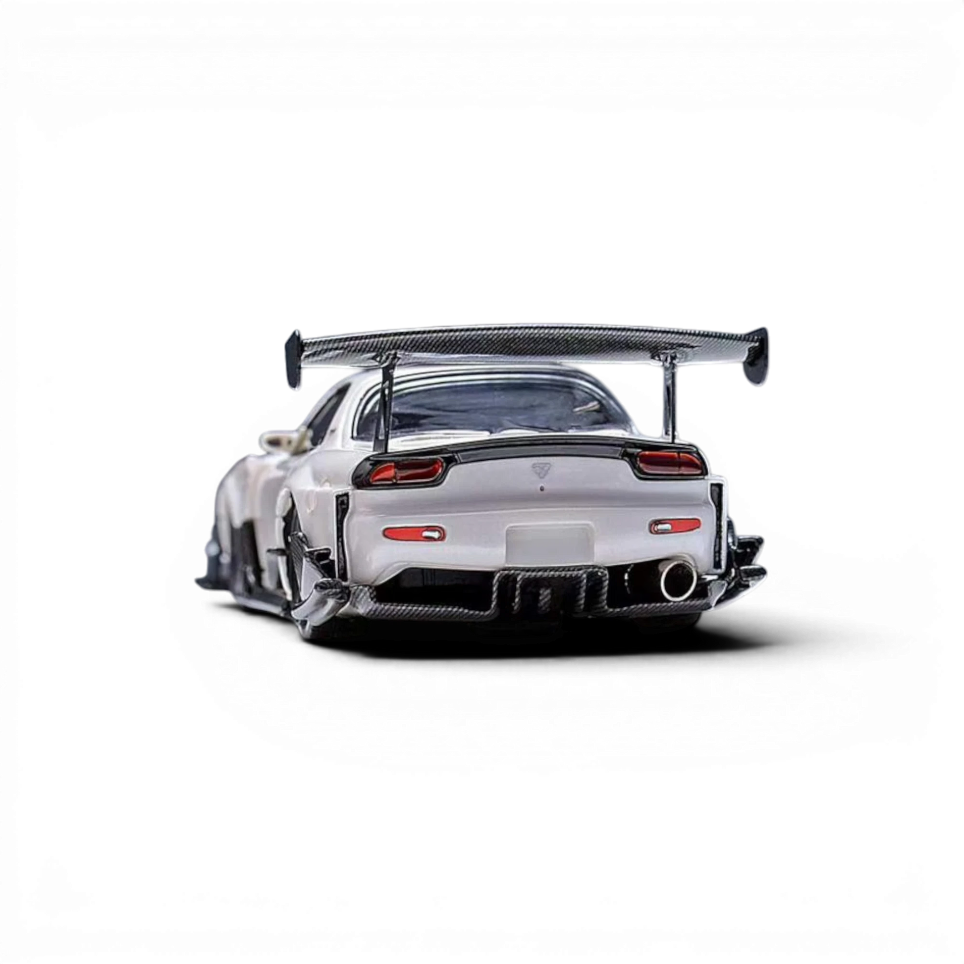 Lot57Supplies Diecast Shop Pearl White Mazda RX-7 FD 1:64 scale model with large carbon fiber wing and detailed exhaust.