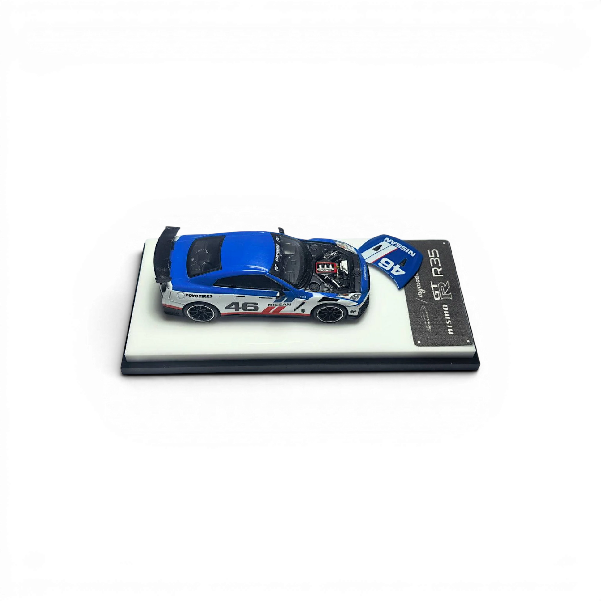 Lot57Supplies Diecast Shop 1:64 scale white and blue MC GTR R35 NISMO #46 diecast model with open hood revealing engine detail.