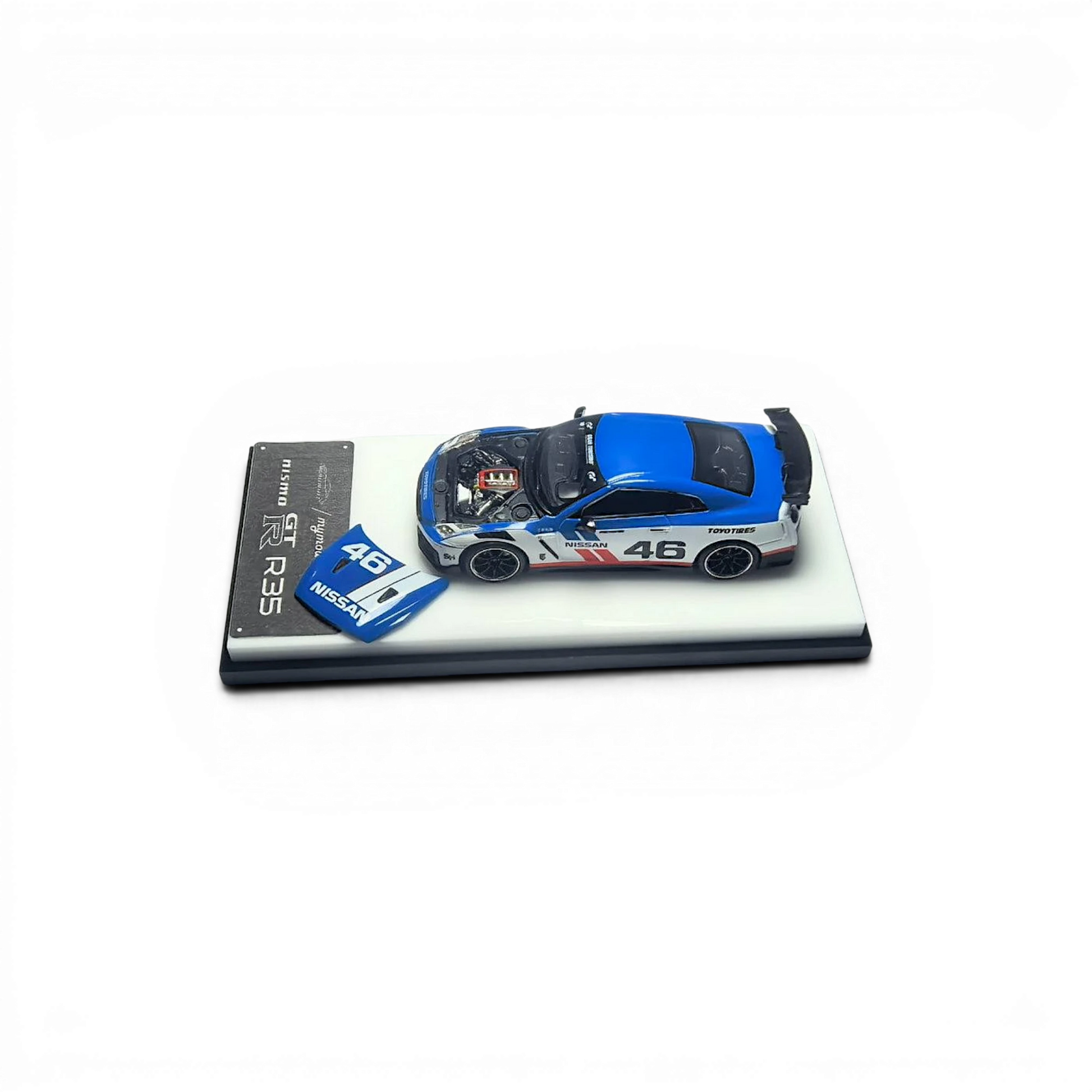 Lot57Supplies Diecast Shop 1:64 scale white and blue MC GTR R35 NISMO model car with open hood revealing engine detail.