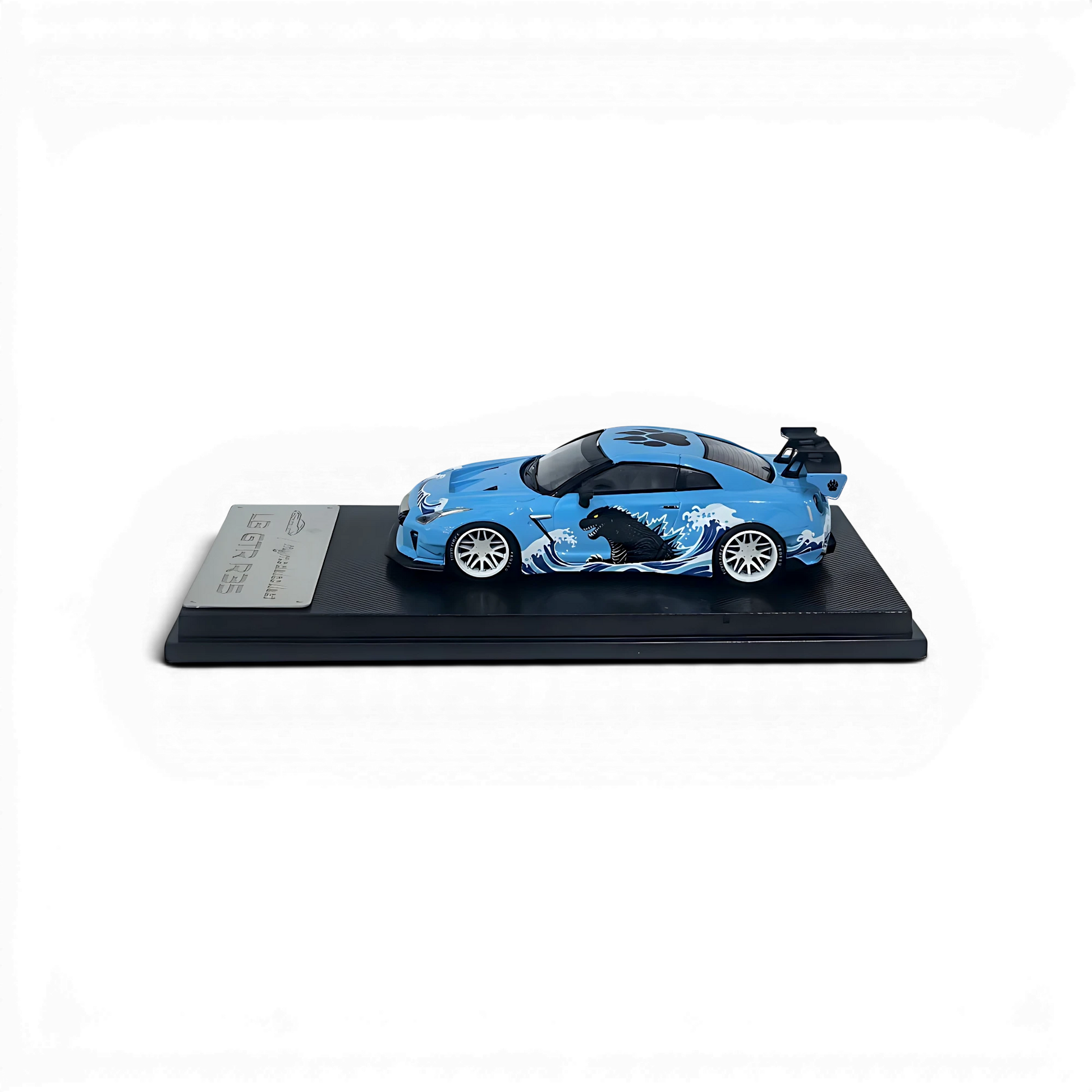 Lot57Supplies Diecast Shop 1:64 scale MC LB GTR diecast model car in blue with Godzilla wave livery on display base