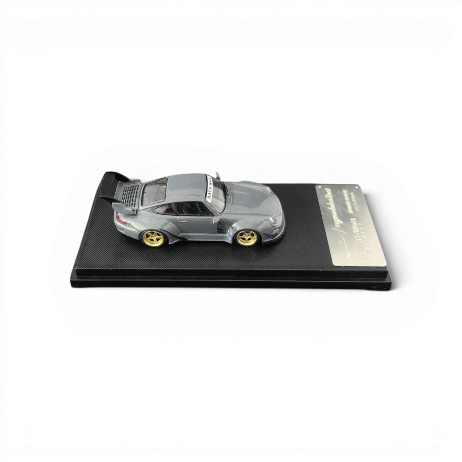 Lot57Supplies Diecast Shop MC RWB 993 G2 Single Deck Wing 1:64 scale model car in cement grey with gold wheels.