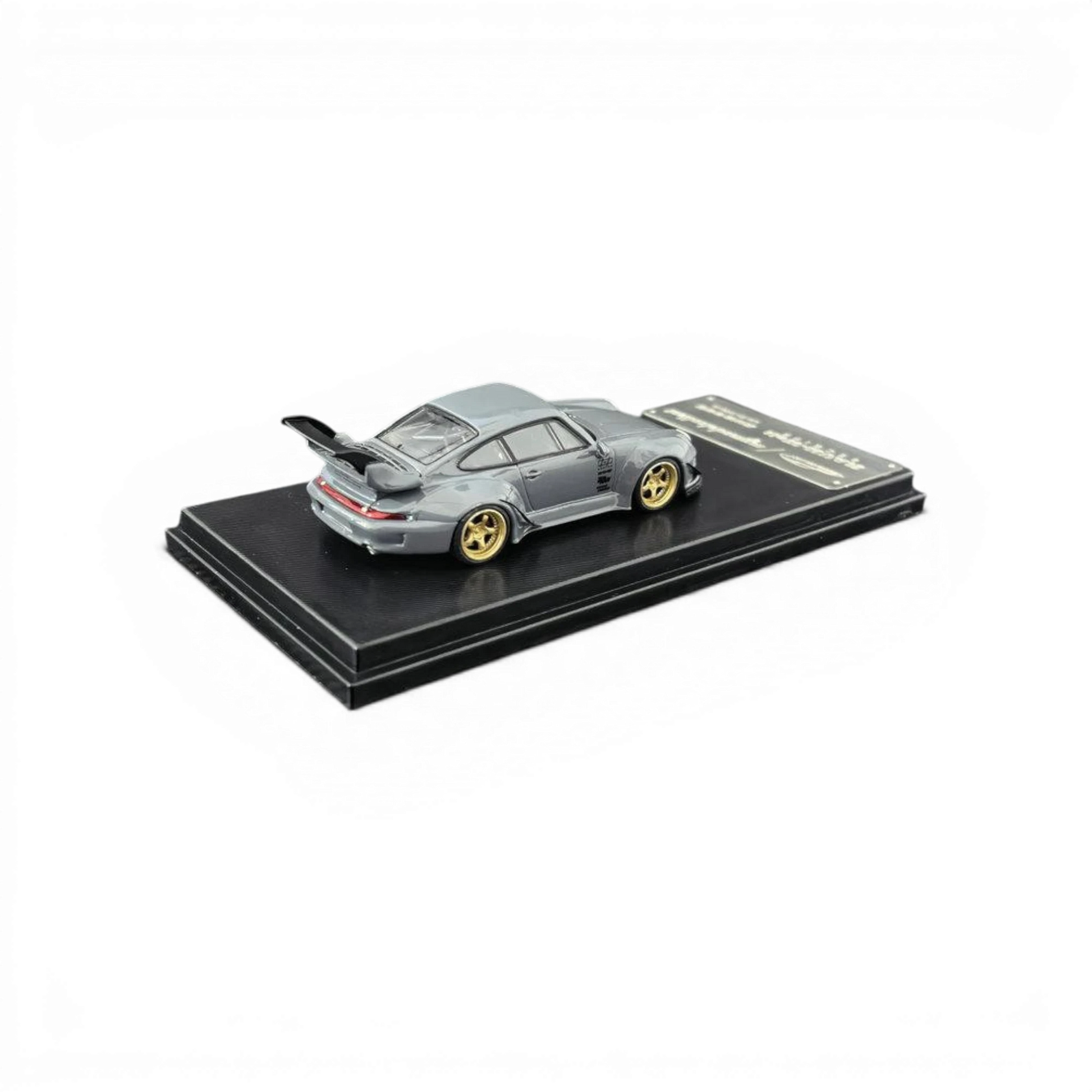 Lot57Supplies Diecast Shop MC RWB 993 G2 Single Deck Wing diecast model car in cement grey with gold wheels, 1:64 scale.