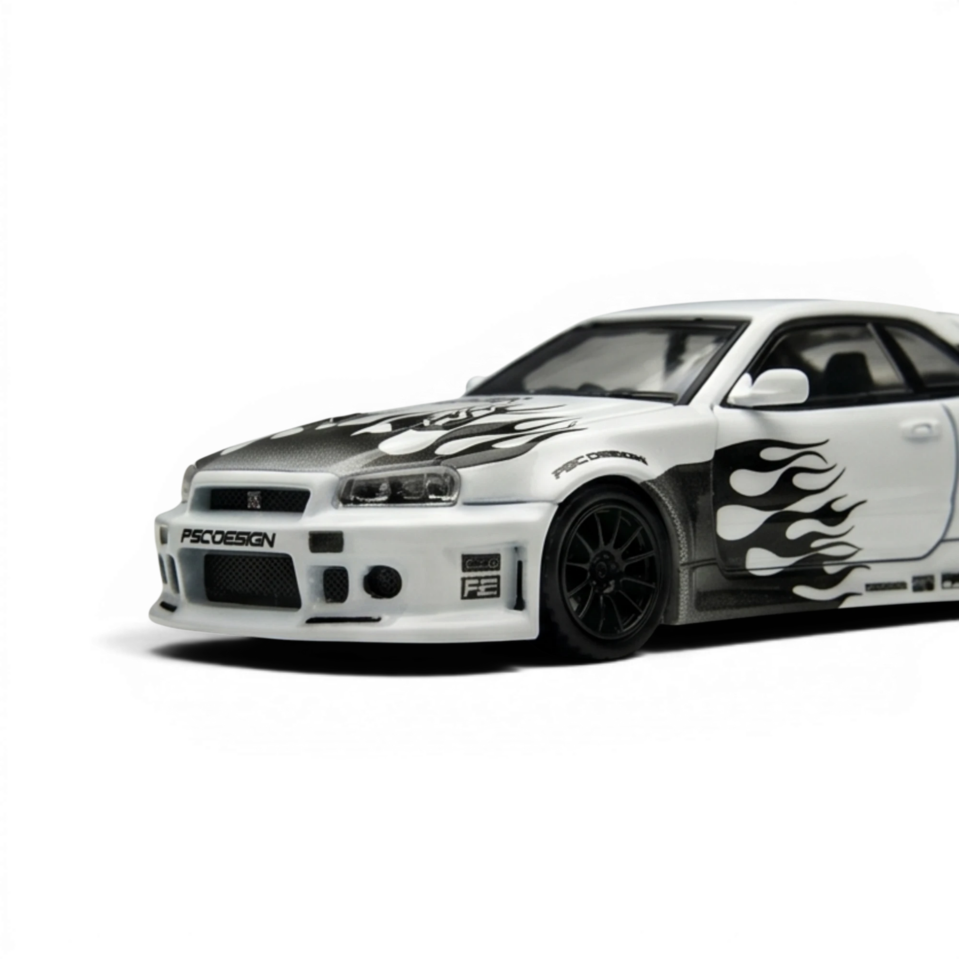 Lot57Supplies Diecast Shop: White 1:64 scale TimeMicro Nissan Skyline R34 GT-R model with black flame graphics and carbon fiber accents.