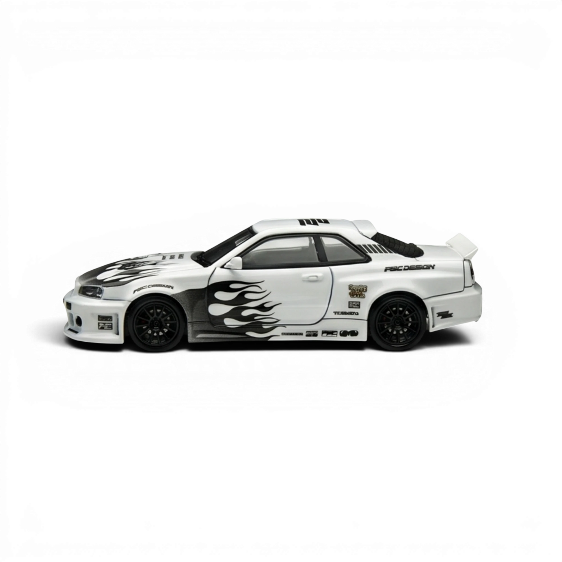 Lot57Supplies Diecast Shop 1:64 scale white Nissan Skyline R34 GT-R model with black flame graphics and racing decals.