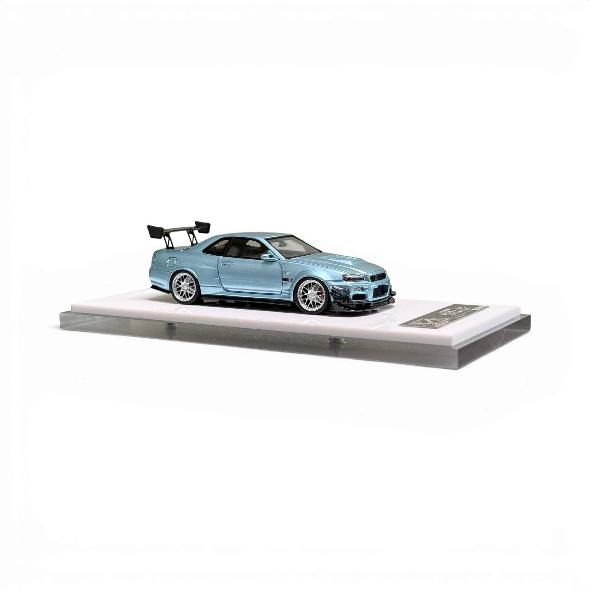 404ERROR Nissan Skyline R34 modified diecast car in ice blue from Lot57Supplies Diecast Shop on a display base.