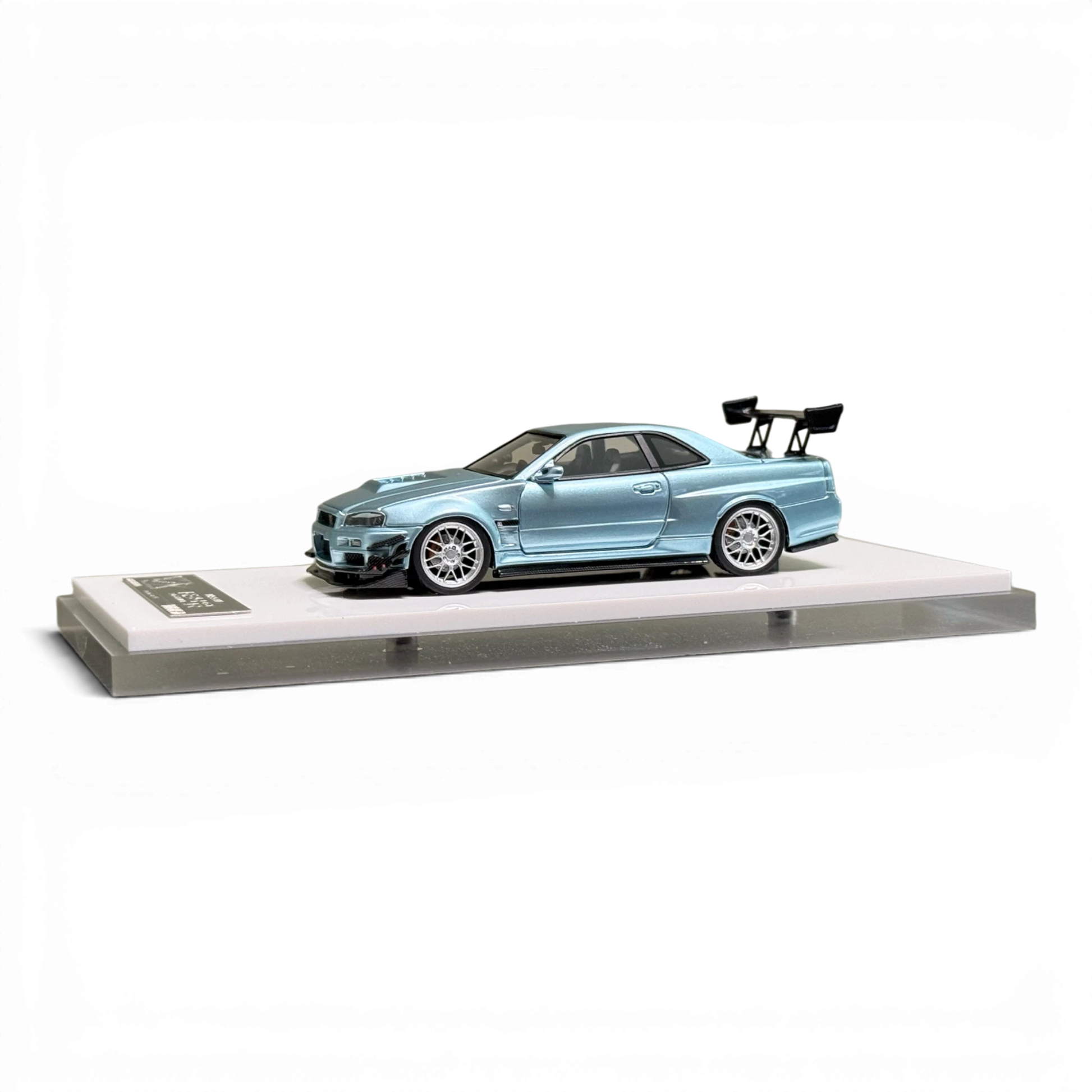 404ERROR Nissan Skyline R34 modified diecast car in ice blue from Lot57Supplies Diecast Shop on a display stand.