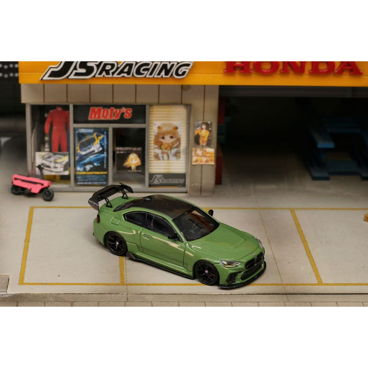 Lot57Supplies Diecast Shop 1:64 scale olive green SW G87 M2 ADRO modified diecast car with high wing parked in diorama