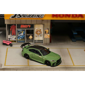 Lot57Supplies Diecast Shop 1:64 scale olive green SW G87 M2 ADRO modified diecast car with high wing parked in diorama