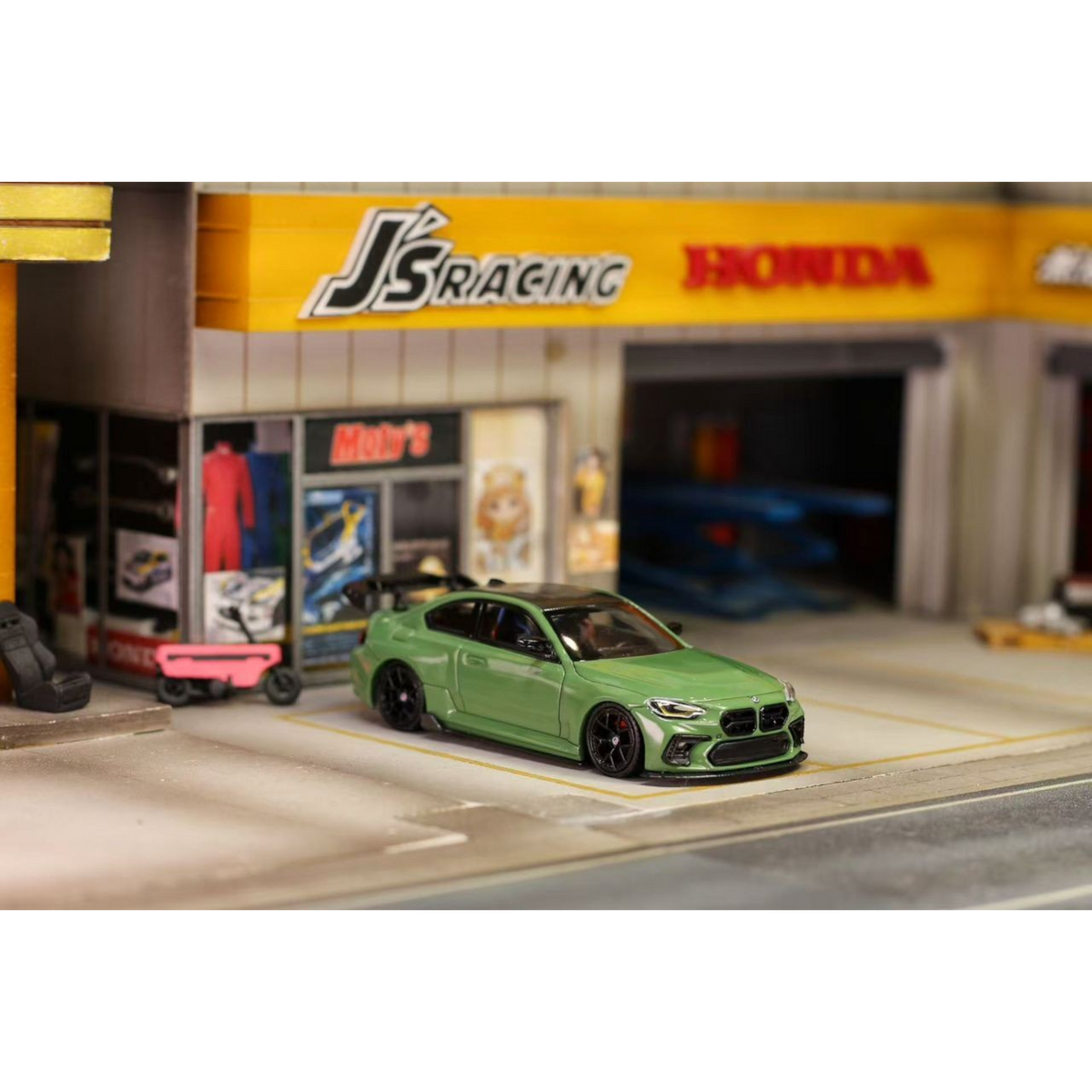 Lot57Supplies Diecast Shop 1:64 scale olive green SW G87 M2 ADRO modified diecast car with high wing on display