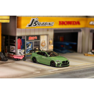 Lot57Supplies Diecast Shop 1:64 scale olive green SW G87 M2 ADRO modified diecast car with high wing on display