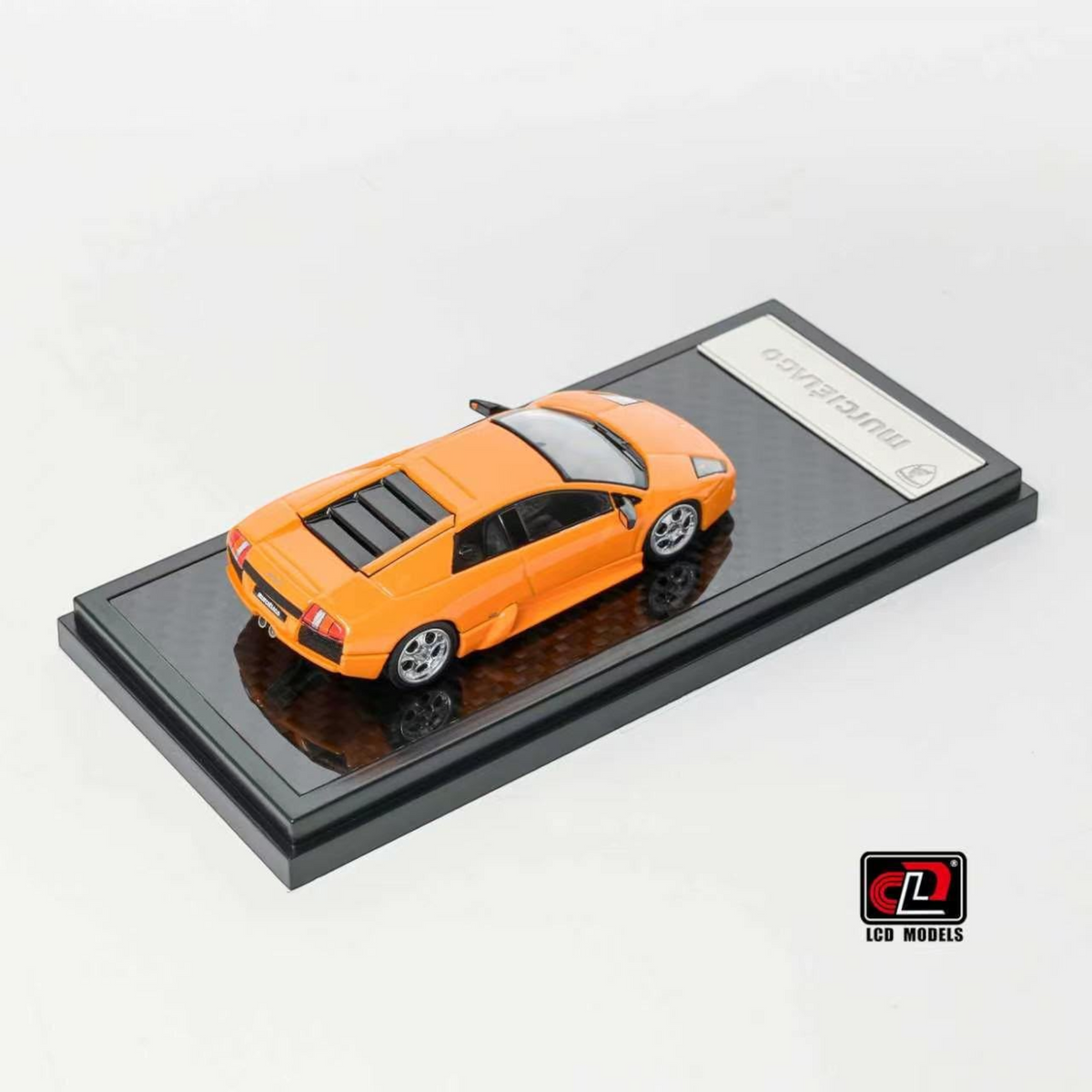 Lot57Supplies Diecast Shop 1:64 scale orange LCD Lamborghini Murciélago diecast model car on a display base