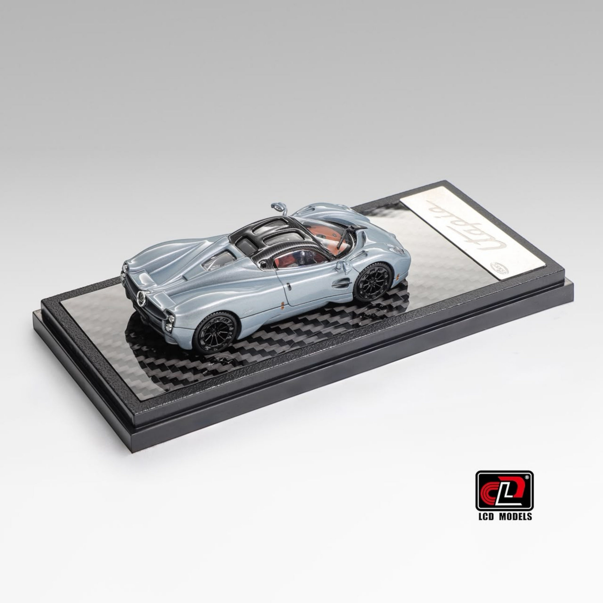 Lot57Supplies Diecast Shop LCD Pagani Utopia 1:64 scale diecast model car in ice blue on a carbon fiber display base
