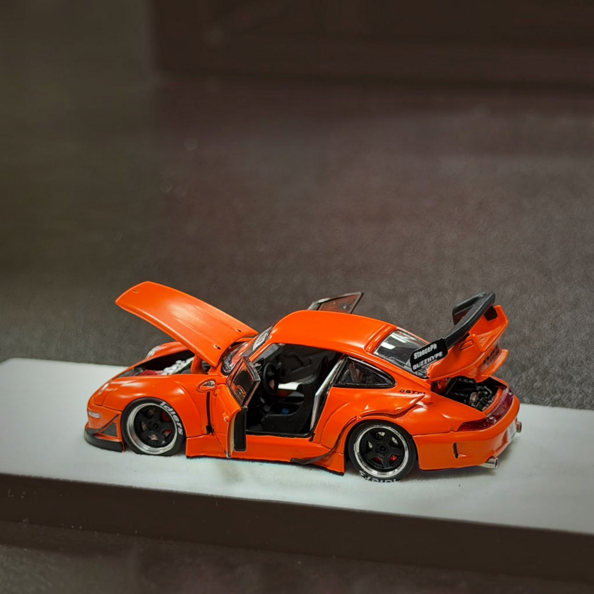Lot57Supplies Diecast Shop PGM RWB 993 diecast model car in matte orange with opening doors, hood, and engine cover.