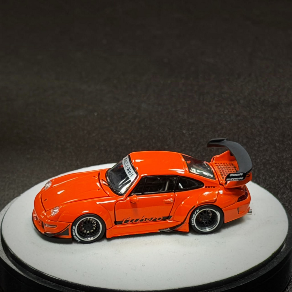 Lot57Supplies Diecast Shop PGM RWB 993 diecast model car in bright thermal orange with black racing wing